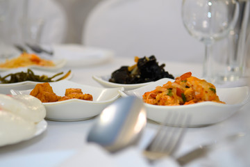 Korean snacks and salads in bowls on the table. Traditional national food in Korea.