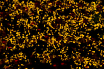 Defocused of orange bokeh blurred circle light from lighting bulb Merry Christmas   and Happy New Year decorative in the night for abstract background texture