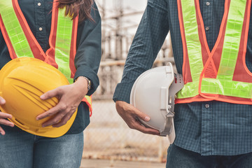 Construction Engineering two people holding helmet hard hat safety work building industrial
