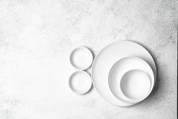 White plates isolated on a light background. Table setting. Top view copy space.