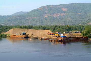 Sand mining. Barges and small boats used for transport of the same. Maharashtra, India