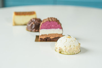 Different delicious and beautiful cakes on the table in a cozy coffee shop