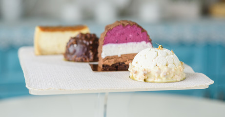 Different delicious and beautiful cakes on the table in a cozy coffee shop