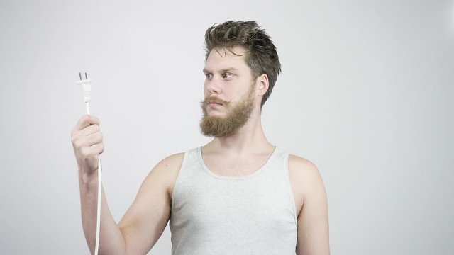 The bearded guy looks at the cable plug. Surprise home electrician