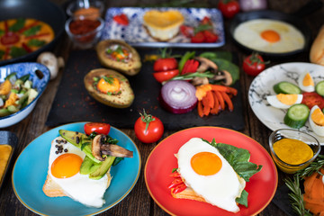 Fried eggs, boiled eggs and omelette on the rustic table
