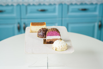 Different delicious and beautiful cakes on the table in a cozy coffee shop