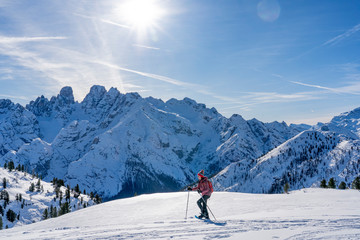 Naklejka na ściany i meble active senior woman snowshoeing from Prato Piazzo up to the Monte Specie in the three oeaks Dolomites area near village of Innichen, South Tyrol, Italy