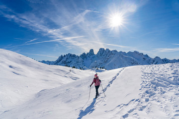 active senior woman snowshoeing from Prato Piazzo up to the Monte Specie in the three oeaks...