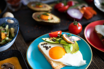 Fried eggs, boiled eggs and omelette on the rustic table