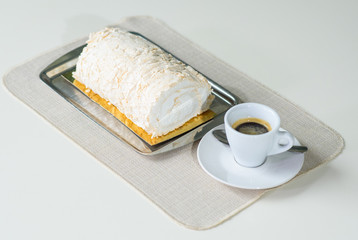 A delicious roll of bezrukov and a cup of coffee on a table in a cozy coffee shop