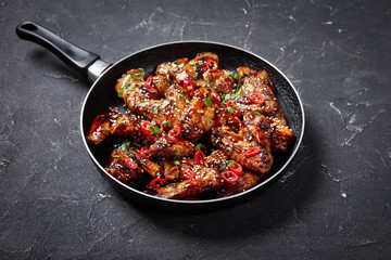 teriyaki chicken wings in a frying pan