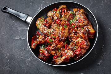 teriyaki chicken wings in a frying pan
