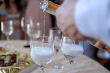 Man pours champagne into glasses 2