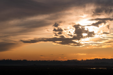 Clouds In front Of Orange Sunset