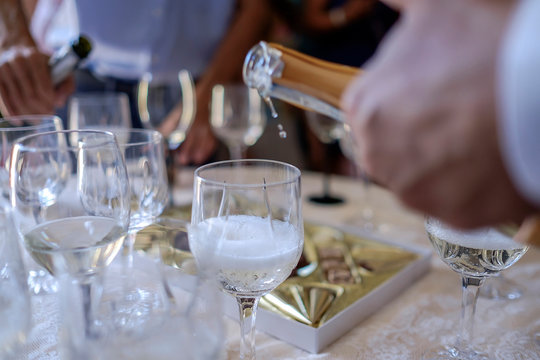 Man pours champagne into glasses 3