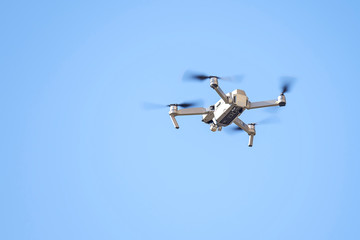 Drone flies in the blue sky 1