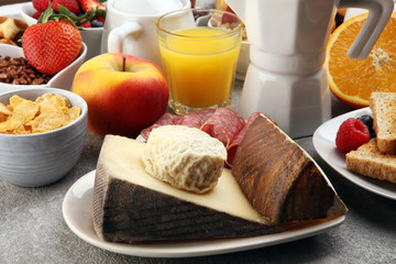 Breakfast served with coffee, orange juice, croissants, cereals and fruits. Balanced diet. Continental breakfast with granola and fruits