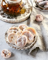 Dried figs with tea in a glass teapot