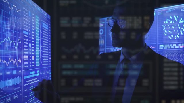 The scientist working with sensor screen on hologram background