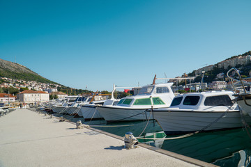 Fototapeta na wymiar Dockside with motor boats lined up along the pier