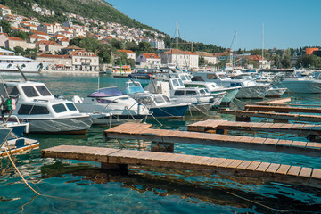 View of moored motor boats and sailboats with personal wooden piers