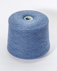 Green bobbin of yarn on a white background.Textile reel on isolated white background.