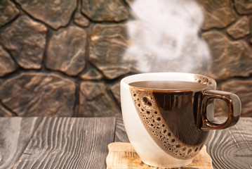Cup of hot coffee on a background of bronze texture