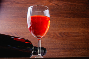 Glass of red wine and a bottle of wine