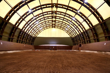 Fototapeta premium View in an indoor riding hall for horses and riders