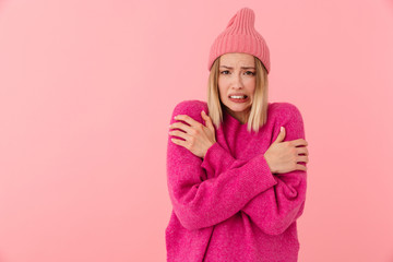 Image of displeased girl wearing hat shaking and trembling from cold