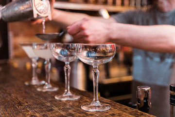 The bartender mixes a summer cocktail at the bar