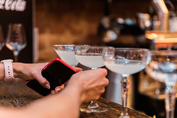 The bartender mixes a summer cocktail at the bar