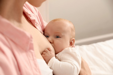 Young woman breast feeding her little baby, closeup