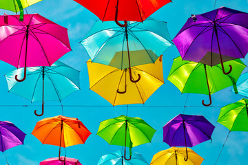 Looking up at the colorful umbrellas. Festive street decoration.