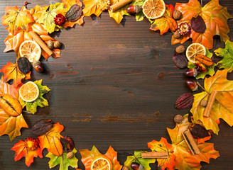 Naklejka na ściany i meble Autumn leaves frame on wooden background