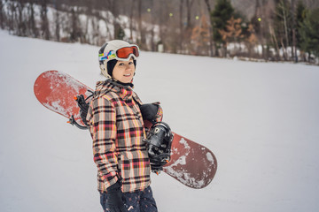 Woman snowboarder on a sunny winter day at a ski resort