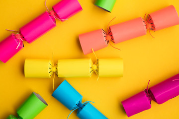 Bright colourful Christmas crackers on a yellow background. festive layflat
