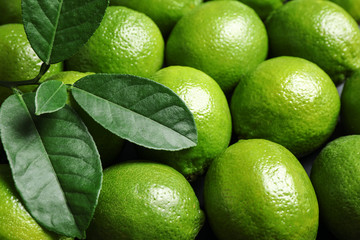 Fresh ripe green limes as background, closeup