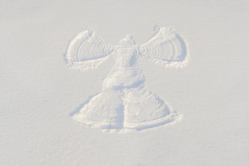 Winter. Snow angel is the imprint of man on the snow, which lay back in the snow and waving his...