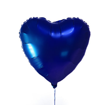 Heart shaped blue balloon on a white background.