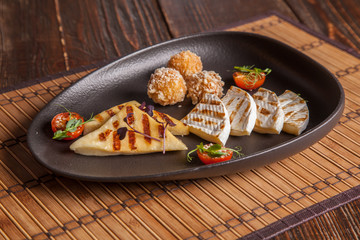 A set of fried cheeses on a plate
