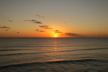 Beautiful crimson red sunset from the beach over the Caribbean Sea in Barbados, Atlantic Ocean