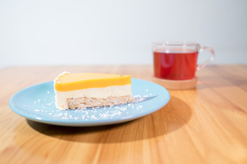 Fototapeta premium Mousse dessert and fruit tea on a large bright wooden table