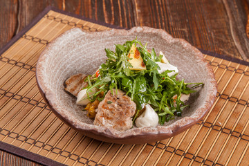 Salad with arugula and roast pork