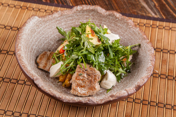 Salad with arugula and roast pork
