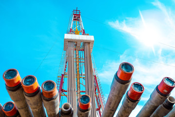 Oil and Gas Drilling Rig onshore dessert with dramatic cloudscape. Oil drilling rig operation on...
