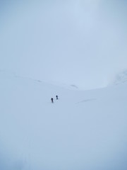 Ski touring, snowboarding and splitboarding in a Beautiful snowy winter mountain landscape in the Swiss alps