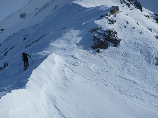 Fototapeta na wymiar Ski touring, snowboarding and splitboarding in a Beautiful snowy winter mountain landscape in the Swiss alps