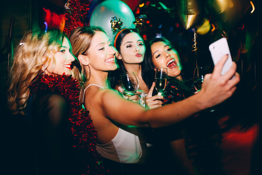 Group of female friends taking selfie during New Year's party at club