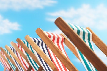 Row of deck chairs on beach close up